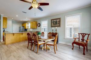 a kitchen and dining room with a table and chairs at Gulfview duplex with panoramic views large balcony and internet in Dauphin Island