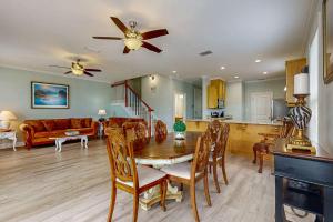 a dining room and kitchen with a table and chairs at Gulfview duplex with panoramic views large balcony and internet in Dauphin Island
