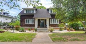 a home with a brick house with a porch at Swimming Under The Stars In The Historical District in Lynchburg