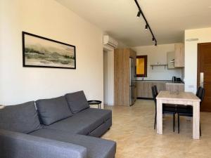 a living room with a couch and a table at Fort Chambray Gozo 2BDR Apartment in Għajnsielem +11 photos