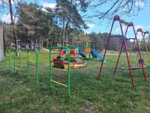 a group of playground equipment in a park at Domki nad Wierną Rzeką in Chęciny