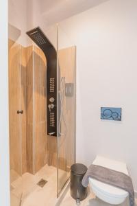 a shower in a bathroom with a toilet at Vivens Mykonos Studios & Suites in Ano Mera +63 photos