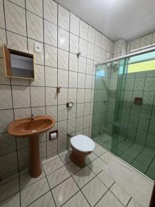 a bathroom with a toilet and a glass shower at Hotel Iung in Alfredo Wagner