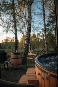 a wooden deck with a hot tub and trees at Skryta Chata Ojców in Smardzowice