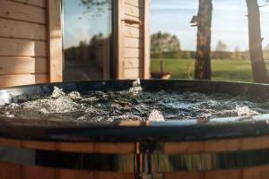a bird bath filled with water in front of a house at Skryta Chata Ojców in Smardzowice