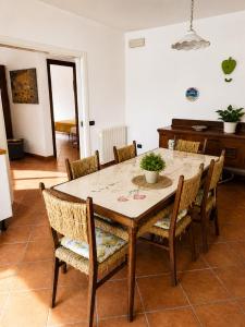 a dining room with a table and chairs at Domus Pannella - Endless Summer in Lacco Ameno