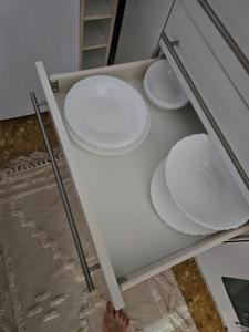 two white plates on top of a table at Sky Apartment in Miramar +11 photos