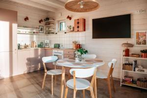 a kitchen with a table and chairs and a tv at Skryta Chata Ojców in Smardzowice +13 photos