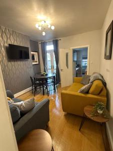 a living room with a couch and a table at Anglesey House in Burton upon Trent