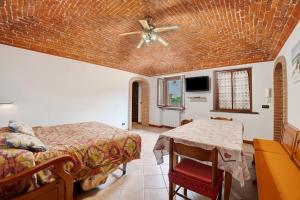 a bedroom with two beds and a ceiling fan at Centenario Affittacamere in Fara Novarese