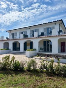 a large white building with balconies on it at Elba Essence Suites in Portoferraio