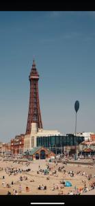 a group of people on a beach with the eiffel tower at Mayfair hotel Blackpool city centre in Blackpool