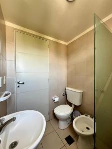 a bathroom with a toilet and a sink and a shower at Casa Akbar in La Cieneguita +45 photos