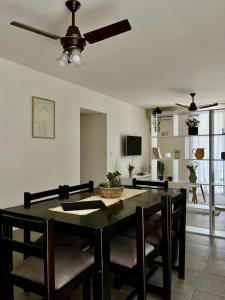 a dining room table with chairs and a ceiling fan at Casa Akbar in La Cieneguita