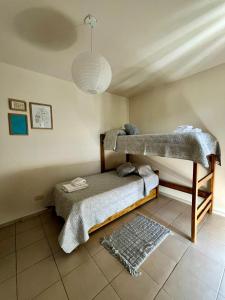 a room with two bunk beds and a rug at Casa Akbar in La Cieneguita