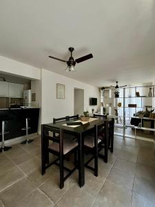 a dining room with a table and a ceiling fan at Casa Akbar in La Cieneguita
