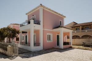 a house with pink and white at Mariu Canal d' Amour in Melíssia
