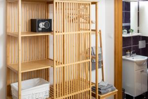 a wooden book shelf with a radio in a bathroom at Jakov & Antonia Heritage Estate in Hvar +190 photos