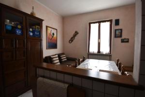 a living room with a bed and a window at Affittacamere Casa Sofia in Anghiari