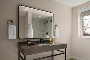 a bathroom with a sink and a large mirror at The Lantern Hotel Columbia in Columbia +32 photos