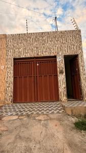 a building with two large garage doors on it at Casa Mobiliada 4 camas e 2 quartos in Juazeiro do Norte