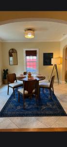 a dining room with a table and chairs on a rug at Casa de David from the 1920s Era in West Palm Beach