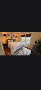 a bedroom with a large bed and a window at Casa de David from the 1920s Era in West Palm Beach +2 photos