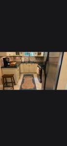 a kitchen with a stainless steel refrigerator and a table at Casa de David from the 1920s Era in West Palm Beach