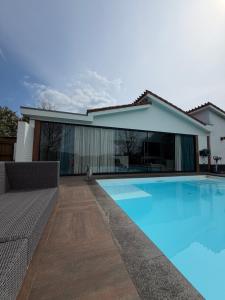 a swimming pool in front of a house at B & B De Allee in Almelo