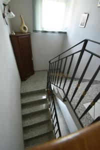 a spiral staircase in a room with a window at Affittacamere Casa Sofia in Anghiari