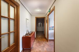 a hallway with a wooden desk and a door at Pensión Zarauz Playa in Zarautz +22 photos