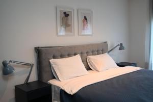 a bed with two pillows on it in a bedroom at Apartment 84 in Donja Lastva
