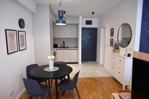 a kitchen and dining room with a table and chairs at Apartment 84 in Donja Lastva
