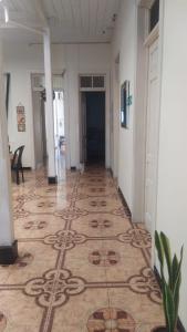 a hallway with a tile floor in a building at Hotel casa inglesa in Buga +1 photo