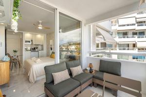 a living room with a couch and a bedroom at Magic View Costa Adeje in Costa de Adeje