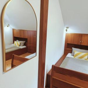 a mirror in a bedroom with a bed and a bed at Hegauzauber in Tengen