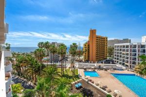 an aerial view of a resort with a swimming pool and the ocean at Magic View Costa Adeje in Costa de Adeje