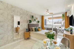 a bedroom with a bed and a glass table at Magic View Costa Adeje in Costa de Adeje