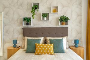 a bedroom with a bed with plants on the wall at Magic View Costa Adeje in Costa de Adeje +24 photos