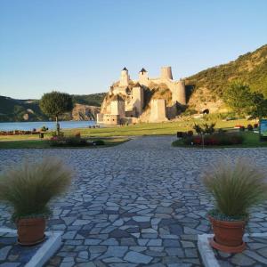 a castle sitting on top of a hill with potted plants at Apartments Barocco in Golubac +16 photos