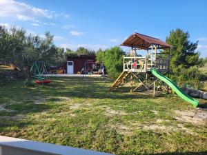 a park with a playground with a slide at Apartments Pitve in Jelsa