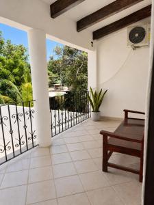 a porch with a bench and a fence at Casa Cultivo in Brisas de Zicatela