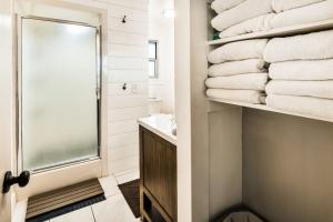 a bathroom with a stack of towels on a shelf at On the Waterfront in Fish Haven +29 photos