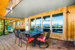 a dining room with a table and chairs on a deck at On the Waterfront in Fish Haven