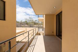 a balcony of a house with a view of the beach at Modern 2BR Condo Close to Downtown Cabo in Cabo San Lucas