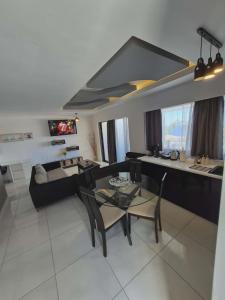 a living room with a couch and a table at Ionian Balcony in Athani