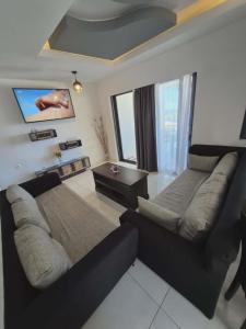 a living room with a couch and a table at Ionian Balcony in Athani