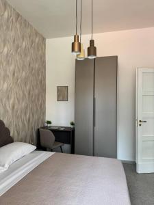a bedroom with a bed and a desk at Mary 's Home in Caserta