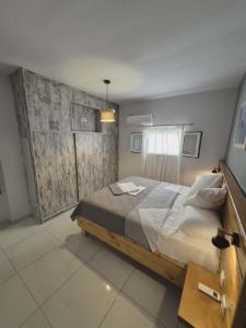 a bedroom with a large bed and a window at Ionian Balcony in Athani