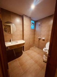 a bathroom with a sink and a toilet at Solo Hotel in Sargodha +28 photos